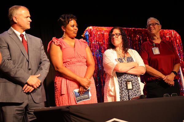 A team of 4 employees collaborate during a round of AIDB Says